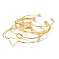 Ensemble de bracelets dorés avec cœur évidé, nœud et perles pour femmes chic - Assortiment de Joncs Nœud Cœur (HS1957-5)