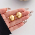 Vintage geometric matte gold round stud earrings held in hand for size visualization - Round Ball Style (HS1061-3)