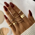 Close-up of golden geometric stackable rings set featuring twisted and minimalist designs - Geometric Smooth Stacking Set (HS1438-4) / 8-piece Set / Gold