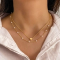 Layered gold necklace featuring delicate pearls and a polished heart pendant on a model - Style 03 / Gold