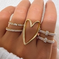Set di anelli dorati sovrapponibili con cuore, cristalli e perle su pelliccia bianca - Set di 5 Anelli Cuore con Strass e Perla Artificiale (HS1981-2) / Oro