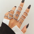 Retro silver multi-piece ring set featuring snake and butterfly motifs on female hand - Infinity Rope Weave (HS1475-51)