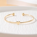 Elegant gold-tone open cuff bracelet with small heart motif and round bead ends - Heart Shape Bead Open Style (HS1974-15)