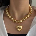 Statement gold ball bead necklace with heart pendant on model wearing white shirt - Gold Single Layer Large Bead Heart Pendant Necklace (HS1979-2)