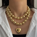 Detailed macro view of a double-layer chunky gold bead necklace with a heart pendant - Gold Double Layer Large Bead Heart Pendant Necklace (HS1979-1)