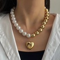 Fashionable faux pearl and gold bead necklace featuring a heart pendant worn by a model - Gold and White Patchwork Artificial Pearl Heart Necklace (HS1979-5)