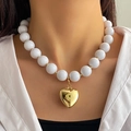 Punk style necklace with large white beads and a bold gold heart pendant on model - White Textured Round Bead Gold Heart Pendant Necklace (HS1979-13)