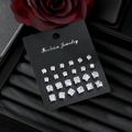 Set of 12 pairs of square-cut cubic zirconia stud earrings in assorted sizes on black card - Square Style (HS1924-3)