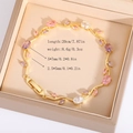 Macro shot of tulip leaf bracelet with colorful crystals and folding clasp in a gift box - Colorful Gold