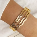 Three-piece gold wave bangles set with twisted metallic texture on a model wrist - Twisted Wave Triple Combination Style (HS1974-12)