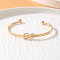 Minimalist gold infinity knot cuff bracelet with smooth parallel wires and bead ends - Infinity Knot Open Bead Style (HS1974-16)