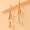 Close-up of gold plated drop earrings with micro-paved zircons and matte metal finish - Curved Multi-Row Rhinestone Inlaid Matte Pendant Style (EH097)