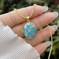 Handheld 18K gold plated locket with light blue enamel and floral design on a bead chain - 18K Gold / Lake Blue