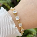 Detailed view of 18k gold plated bracelet with square zircons worn on a wrist - White