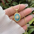 Detailed macro of the gold locket necklace with sky blue enamel and starburst charm - 18K Gold / Sky Blue