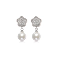 Macro detail of silver floral earrings featuring pavé cubic zirconia and white pearls - EH286 Flower Silver Style