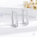 Macro detail of silver rectangular earrings featuring pavé-set zircons on white background - Silver (EH545)