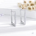 Detail of rectangular hoop earrings featuring a row of sparkling white zircons and silver finish - Silver (EH547)