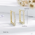 Macro shot of gold rectangle huggie earrings with AAA cubic zirconia inlays - Gold (EH551)