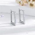 Macro shot of silver rectangle huggie earrings featuring pavé-set round cubic zirconia - Silver (EH551)