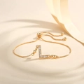 Detail view of gold-plated bolo bracelet with letter L pendant and micro-inlaid zircons - Letter L