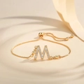 Detail of adjustable gold-plated M initial bracelet with zircon stones and box chain - Letter M