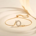Detail of gold adjustable bracelet with sparkling letter O charm and sliding buckle clasp - Letter O
