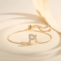 Detailed macro view of gold letter P pendant with sparkling cubic zirconia on a slider chain - Letter P