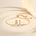 Close-up of gold-plated adjustable chain bracelet featuring a zircon-encrusted letter U charm - Letter U