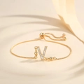Detail of adjustable gold-plated bracelet with Zircon-encrusted letter V charm pendant - Letter V