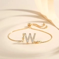 Detail of adjustable gold-plated letter W bracelet with sparkling pavé cubic zirconia - Letter W
