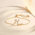 Macro shot of gold plated snake chain bracelet featuring zircon inlaid letter Y charm - Letter Y