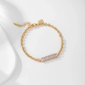 Detail of gold-plated chain bracelet with marquise-cut zircons and HYL logo tag - Gold Chain Pink