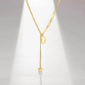 Detailed shot of gold-plated letter D pendant necklace with cubic tassel accent - Letter D