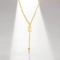 Detailed view of gold-plated letter E pendant necklace with modern asymmetrical chain design - Letter E