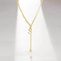 Detailed view of gold-plated Y-necklace with tassel and initial S letter pendant - Letter S