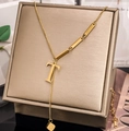 Detailed view of gold plated Y-necklace with T-letter pendant and metallic bar accents - Letter T