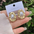Dettaglio degli orecchini a cuore placcati oro con perle su carta per gioielli - Perla Ovale Martellata Irregolare (1) / Oro