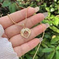Detail of 18K gold plated heart necklace with G initial and shimmering zircon accents - 18K Gold / Gold G