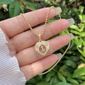 Detail of 18K gold heart pendant with crystal letter I held against nature background - 18K Gold / Gold I