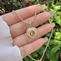 Macro detail of 18K gold plated heart wing pendant with zircon letter R on beaded chain - 18K Gold / Gold K