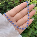 Detailed macro of the 18K gold plated evil eye beaded necklace with blue eye charms - Necklace / Blue