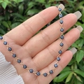 Macro detail of 18K gold plated evil eye bracelet with blue enamel beads on human hand - Necklace / Blue