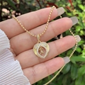 Close-up of 18K gold plated heart pendant with zircon letter N and beaded chain - 18K Gold / Gold N