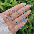 Close-up of 18K gold-plated Evil Eye necklace and bracelet set with blue charms - Necklace And Bracelet / Blue