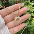 Macro view of 18K gold-plated heart pendant with zircon wings and movable letter T - 18K Gold / Gold T