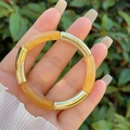 Macro detail of amber resin bamboo joints and polished gold metal segments on bracelet - Amber and Gold (4)