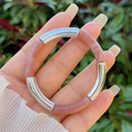 Detail of bamboo-style elastic resin bracelet with silver metal on a woman's wrist - Meat Pink Marble Silver Style (3)