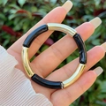 Detail of bamboo-style resin bracelet with alternating gold polished and black tubes - Black Glossy Gold Style (7)