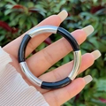 Detail of a minimalist resin bangle showing silver metal and black tube segments - Black Glossy Silver Style (8)